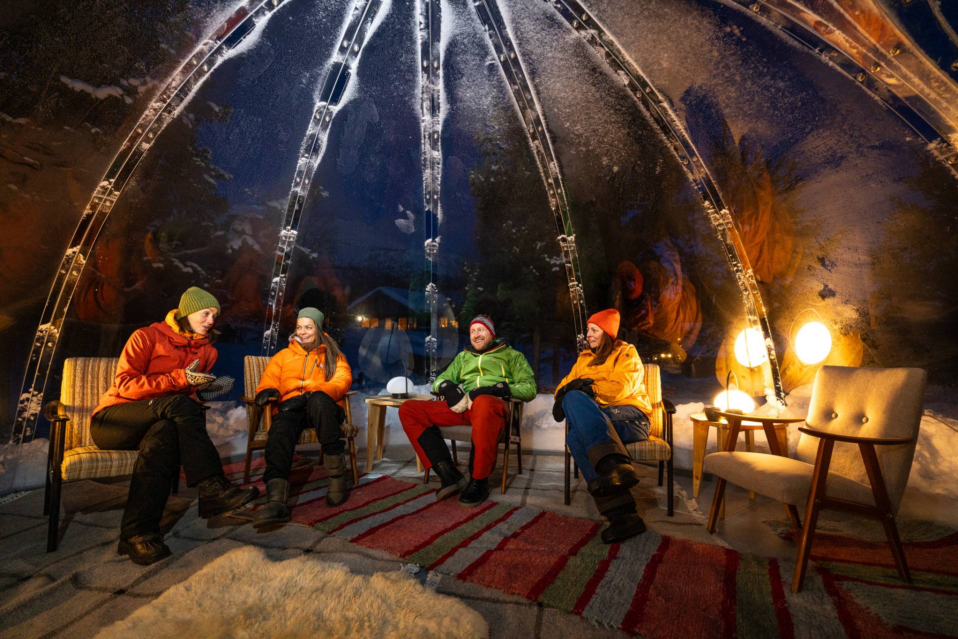 people sitting in the cozy shared aurora dome